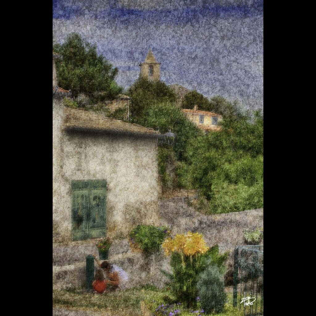 Mother and daughter playing at a watering hole with flowers in Entrevennes, a small village in southern France