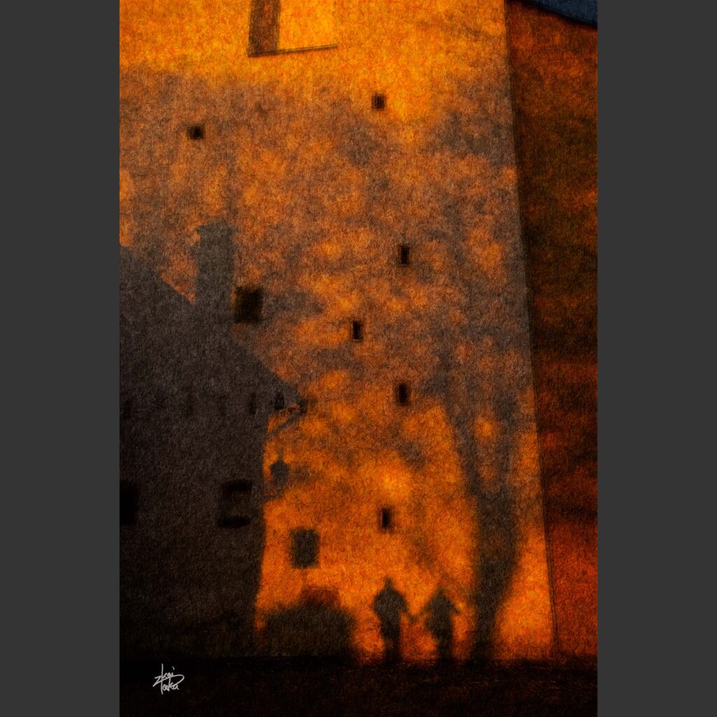 A couple's shadows cast by the setting sun in Bishop's Garden on the wall of the Church of Our Lady of the Angels