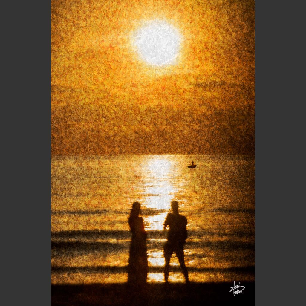 A couple watches the sunrise on the beach in Da Nang, Vietnam.