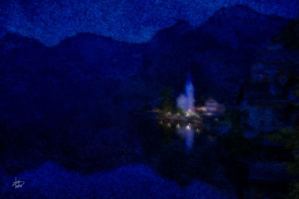 Hallstatt in Austria before dawn reflected on the mirror-like surface of the lake