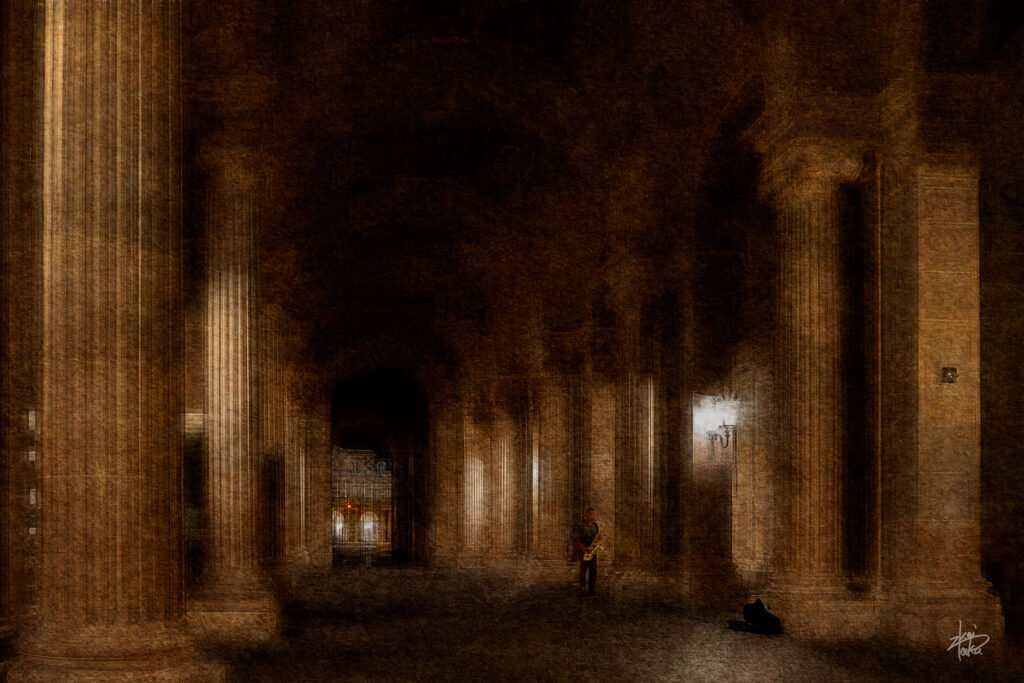 Musician playing saxophone at the Louvre Museum at night, Paris