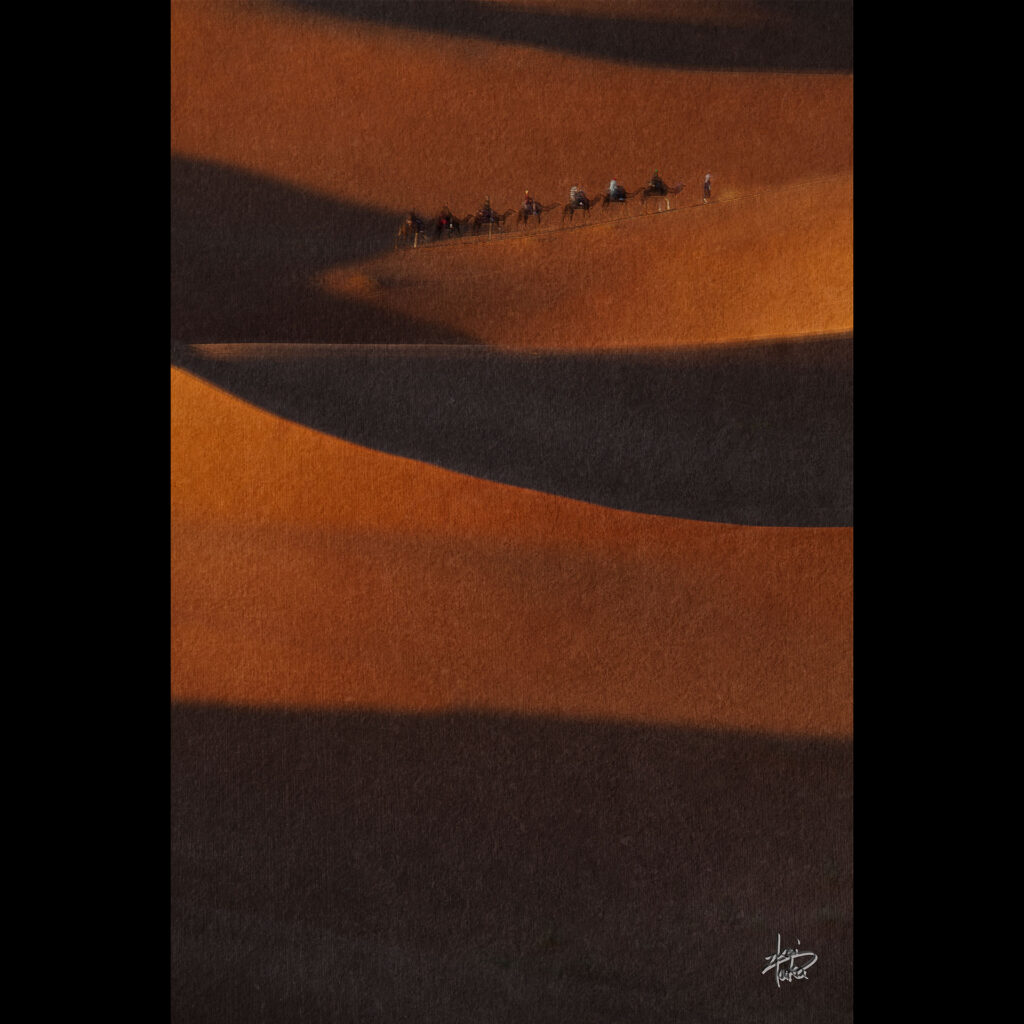 Tourists riding camels through the Sahara Desert, Morocco